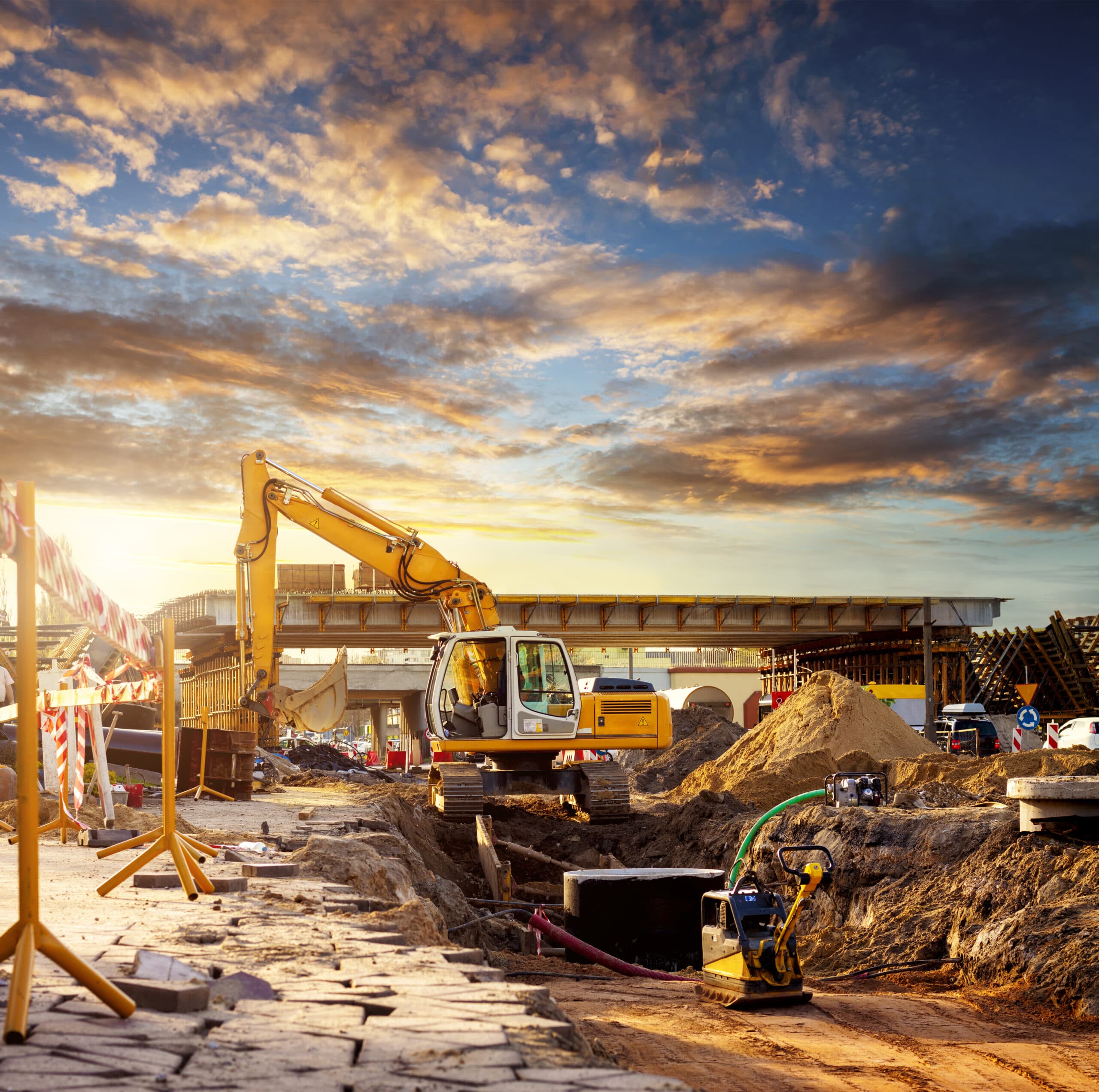 Large excavator caterpillar on a construction site. Excavator on a road construction site.