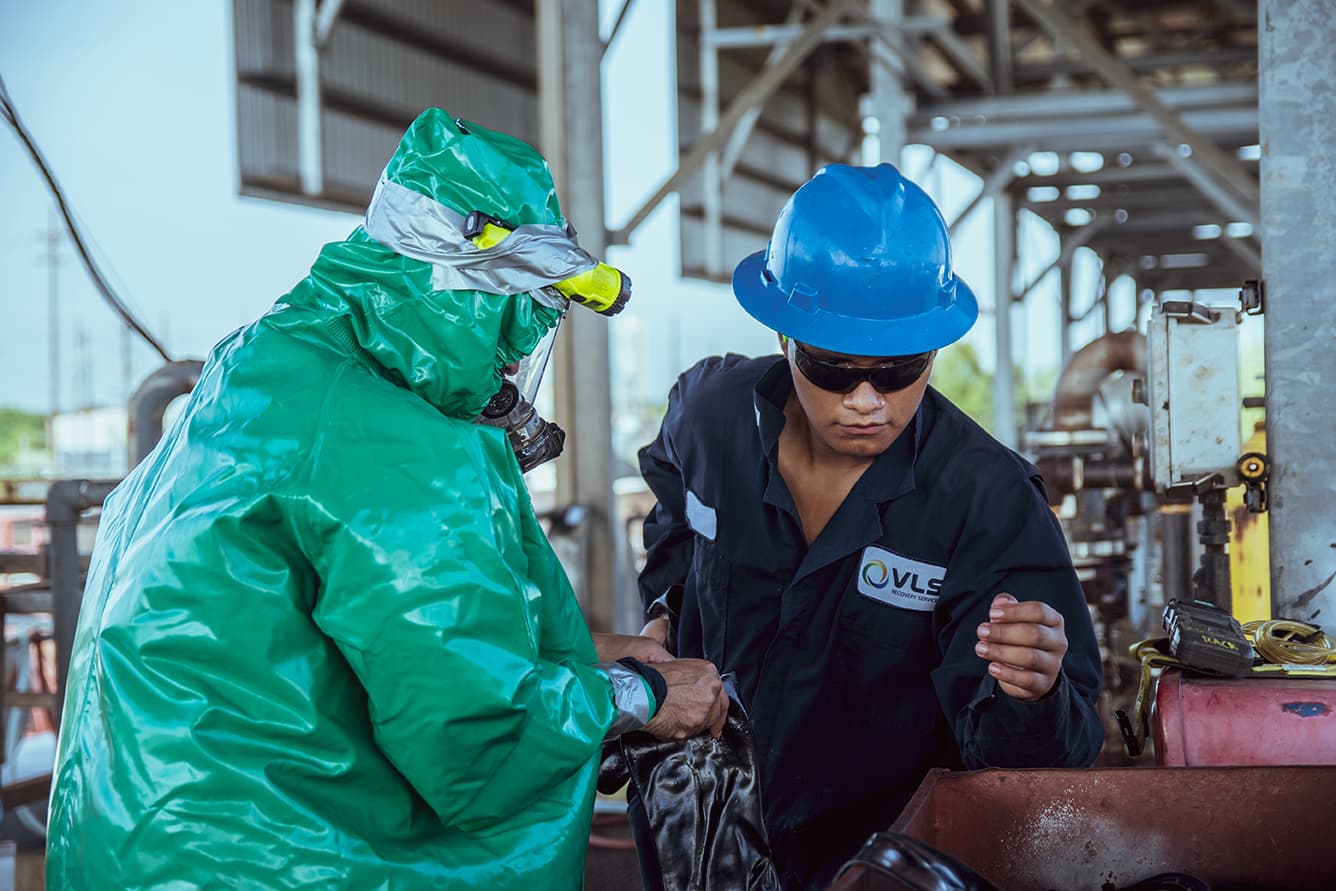 Two people in an industrial work setting.